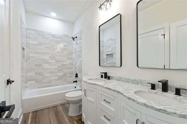 5567 Tyree Rd, Winston, GA 30187 - bathroom featuring wood finished floors, toilet, double vanity, bathing tub / shower combination, and recessed lighting