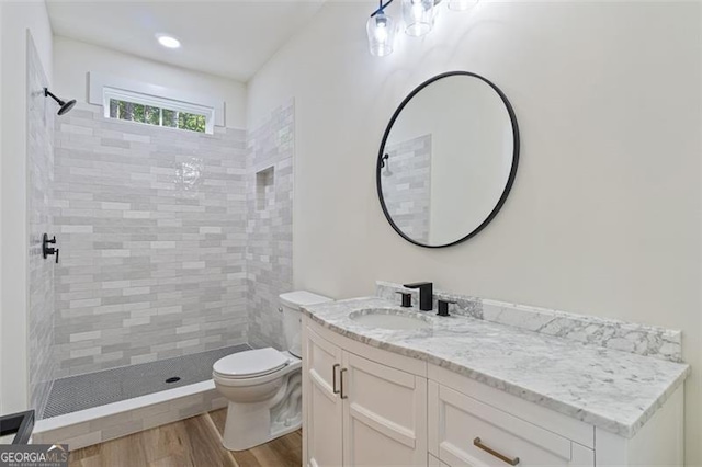 5567 Tyree Rd, Winston, GA 30187 - bathroom with a tile shower, vanity, toilet, and wood finished floors