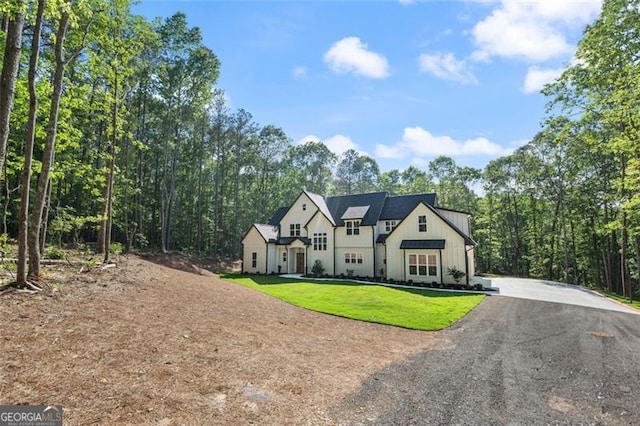 5567 Tyree Rd, Winston, GA 30187 - view of front of property featuring board and batten siding, a front yard, and driveway