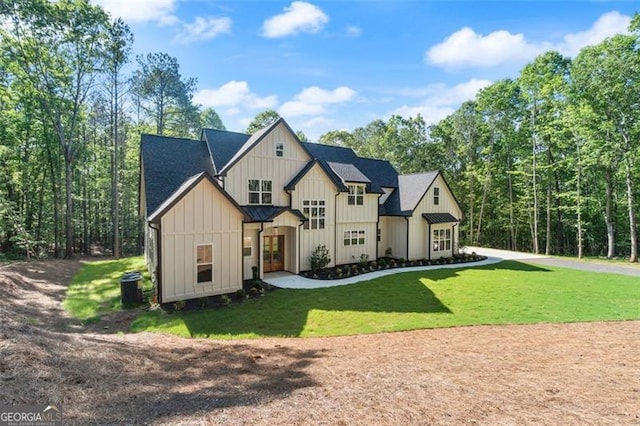 5567 Tyree Rd, Winston, GA 30187 - back of property with board and batten siding, a yard, and french doors