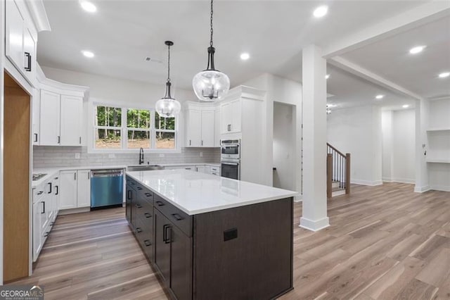 5567 Tyree Rd, Winston, GA 30187 - kitchen with stainless steel appliances, backsplash, light countertops, white cabinets, and recessed lighting