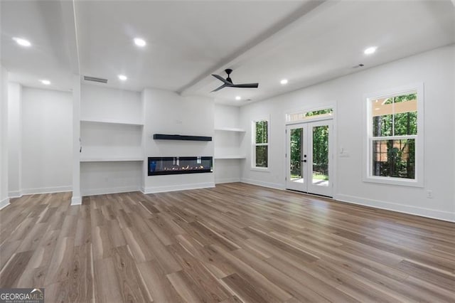 5567 Tyree Rd, Winston, GA 30187 - unfurnished living room with wood finished floors, baseboards, ceiling fan, a glass covered fireplace, and recessed lighting