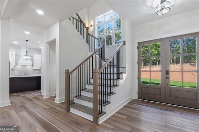 5567 Tyree Rd, Winston, GA 30187 - entrance foyer with stairway, wood finished floors, french doors, baseboards, and recessed lighting