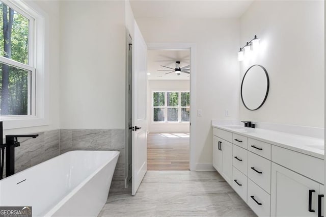 5567 Tyree Rd, Winston, GA 30187 - bathroom with ceiling fan, double vanity, a soaking tub, and marble finish flooring
