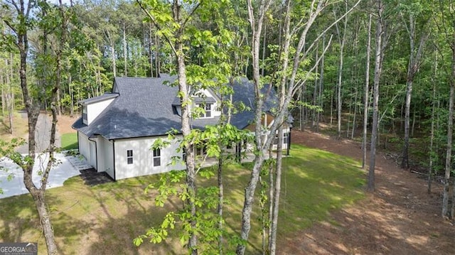 5567 Tyree Rd, Winston, GA 30187 - exterior space with roof with shingles, stucco siding, an attached garage, driveway, and a forest view