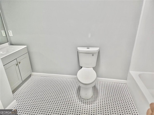 3045 Revere Cir, Snellville, GA 30039 - bathroom with baseboards, toilet, a bathtub, and vanity