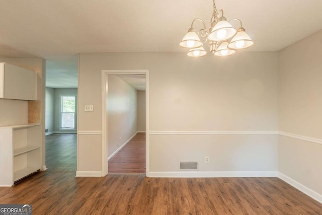 2499 Shiloh Dr, Decatur, GA 30034 - unfurnished dining area with a chandelier, wood finished floors, and baseboards