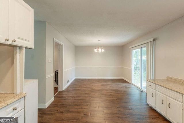 2499 Shiloh Dr, Decatur, GA 30034 - unfurnished dining area featuring dark wood-type flooring, a chandelier, and baseboards