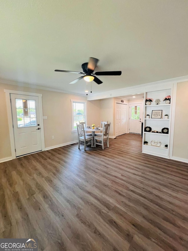 dining space with ornamental molding, wood finished floors, ceiling fan, baseboards, and built in features