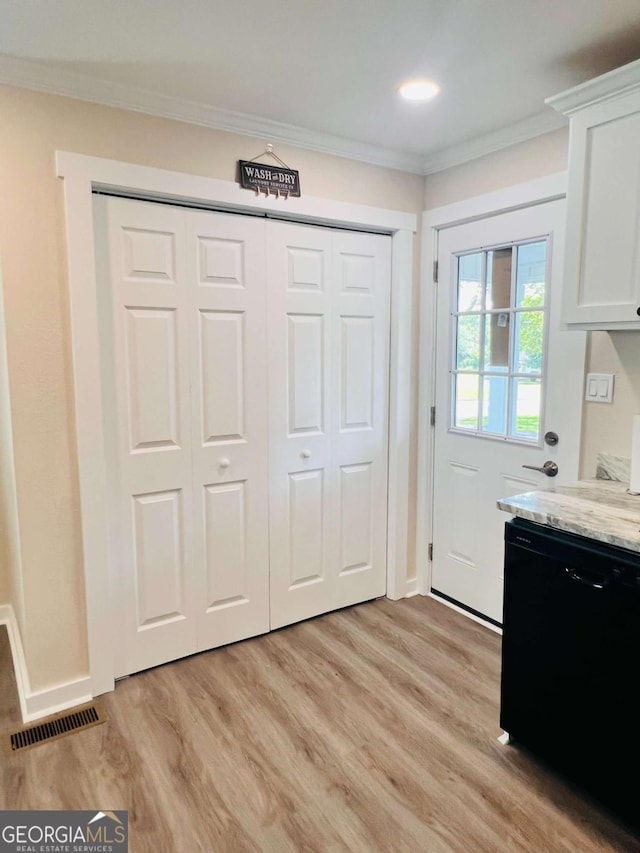 kitchen with dishwasher, light wood finished floors, light stone countertops, white cabinets, and ornamental molding