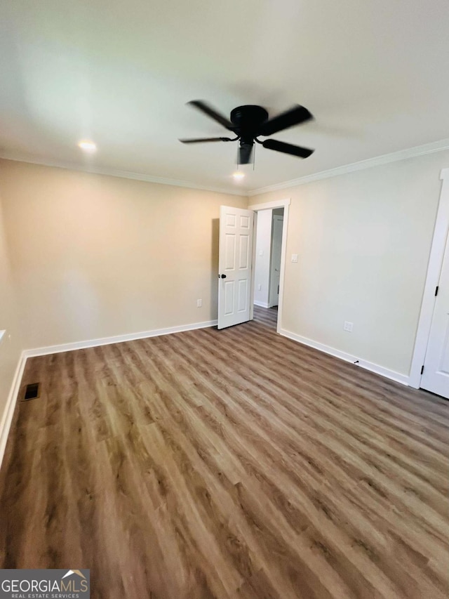 unfurnished bedroom with wood finished floors, baseboards, crown molding, and a ceiling fan