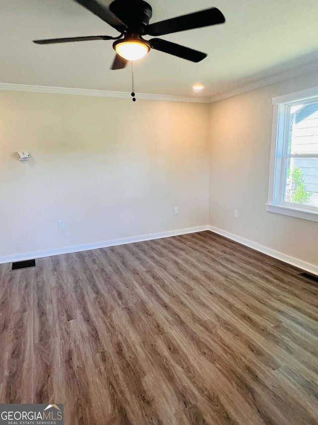unfurnished room featuring ornamental molding, wood finished floors, a ceiling fan, and baseboards