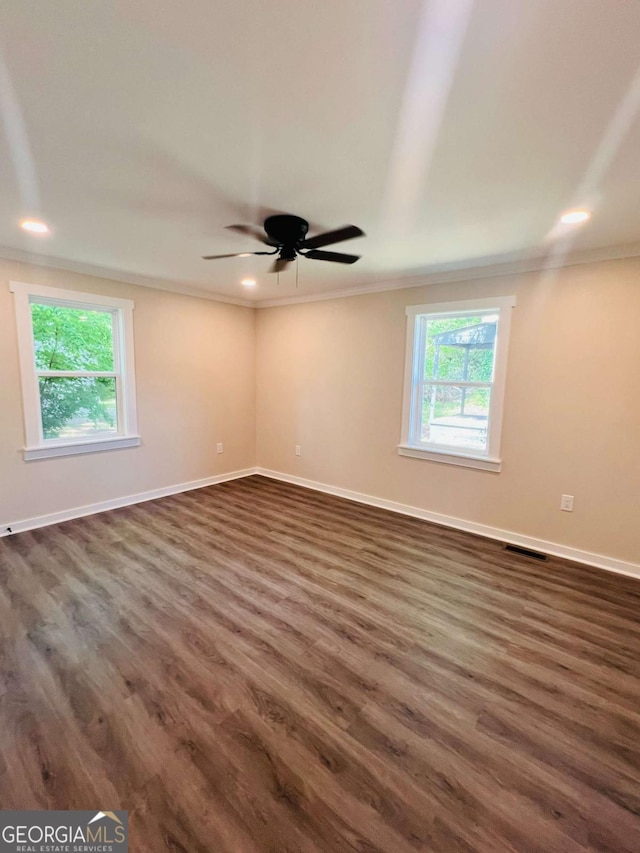 empty room featuring ornamental molding, dark wood finished floors, baseboards, ceiling fan, and recessed lighting