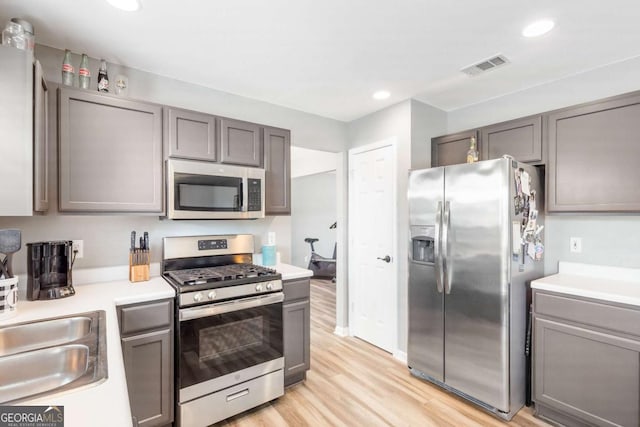 1194 Grandview Cir, Powder Springs, GA 30127 - kitchen with stainless steel appliances, gray cabinetry, light wood-type flooring, and recessed lighting