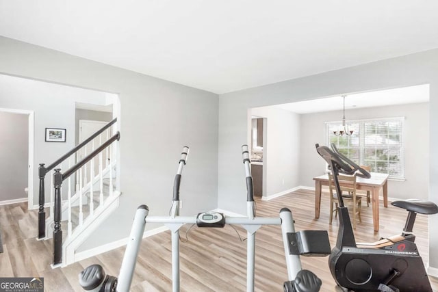 1194 Grandview Cir, Powder Springs, GA 30127 - workout area with light wood finished floors, a chandelier, and baseboards