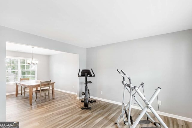 1194 Grandview Cir, Powder Springs, GA 30127 - workout room featuring light wood-style floors, baseboards, and a chandelier