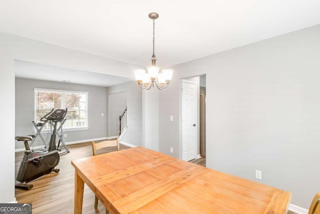 1194 Grandview Cir, Powder Springs, GA 30127 - dining room with a chandelier, light wood-type flooring, stairway, and baseboards