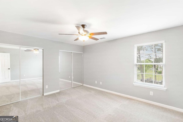 1194 Grandview Cir, Powder Springs, GA 30127 - unfurnished bedroom with multiple closets, carpet floors, baseboards, and ceiling fan