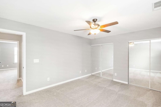 1194 Grandview Cir, Powder Springs, GA 30127 - unfurnished bedroom with multiple closets, carpet floors, baseboards, and ceiling fan