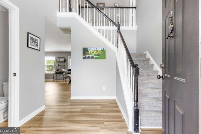 1194 Grandview Cir, Powder Springs, GA 30127 - entryway featuring light wood-style floors, baseboards, stairway, and a high ceiling