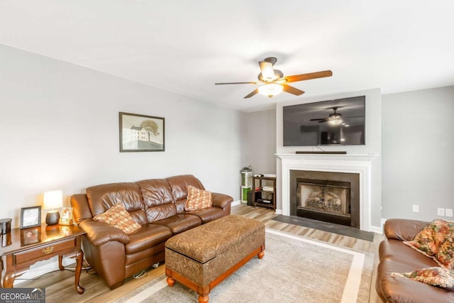 1194 Grandview Cir, Powder Springs, GA 30127 - living area featuring wood finished floors, a ceiling fan, and a fireplace with flush hearth