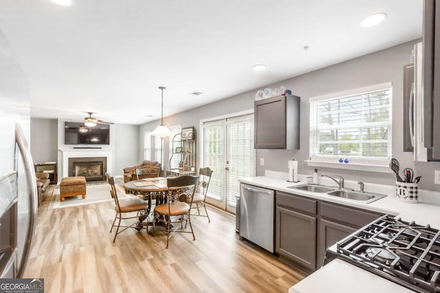 1194 Grandview Cir, Powder Springs, GA 30127 - kitchen featuring dishwasher, a sink, healthy amount of natural light, a glass covered fireplace, and recessed lighting