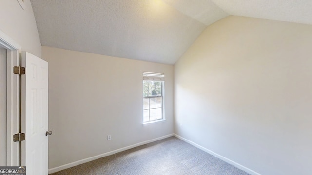 4162 Ward Lake Trl, Ellenwood, GA 30294 - unfurnished bedroom featuring vaulted ceiling, carpet flooring, and baseboards
