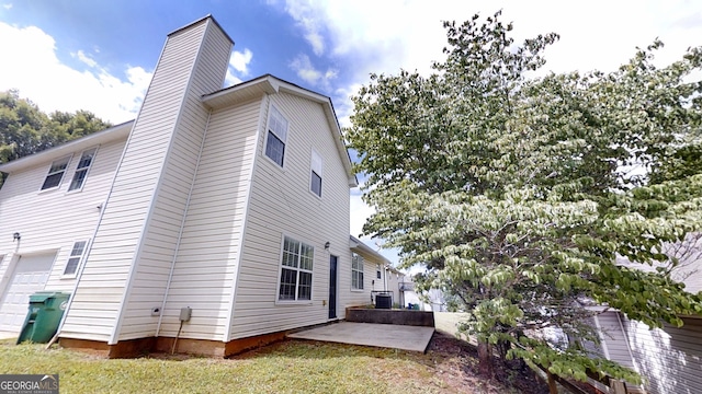 4162 Ward Lake Trl, Ellenwood, GA 30294 - view of side of home featuring a chimney, central AC, and a patio area