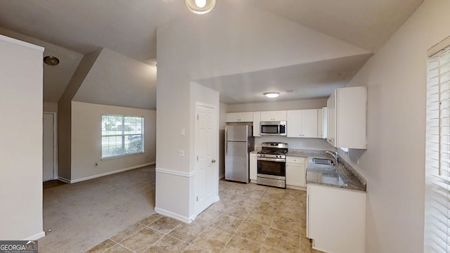 4162 Ward Lake Trl, Ellenwood, GA 30294 - kitchen featuring appliances with stainless steel finishes, a sink, white cabinets, light tile patterned flooring, and lofted ceiling