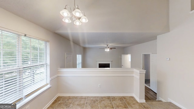 4162 Ward Lake Trl, Ellenwood, GA 30294 - unfurnished living room with a ceiling fan, a fireplace, a chandelier, and baseboards