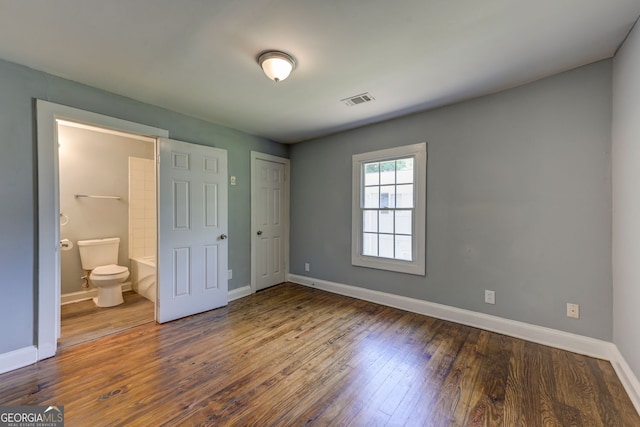 103 Chicamauga Ave SW, Atlanta, GA 30314 - unfurnished bedroom featuring baseboards, wood finished floors, ensuite bath, and a closet