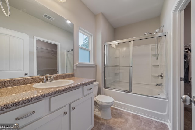 385 Orchard Land, Covington, GA 30014 - full bathroom with toilet, vanity, a walk in closet, and bath / shower combo with glass door