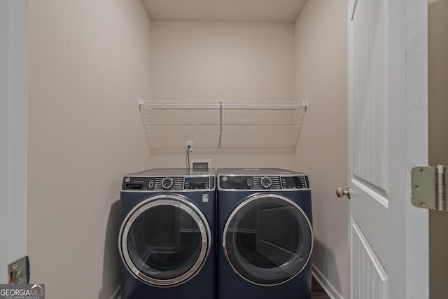 385 Orchard Land, Covington, GA 30014 - clothes washing area with washing machine and clothes dryer and baseboards