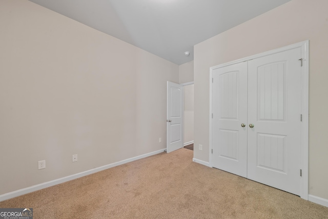 385 Orchard Land, Covington, GA 30014 - unfurnished bedroom featuring carpet, baseboards, and a closet