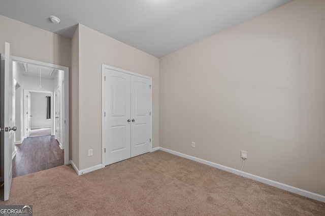 385 Orchard Land, Covington, GA 30014 - unfurnished bedroom featuring attic access, carpet floors, baseboards, and a closet