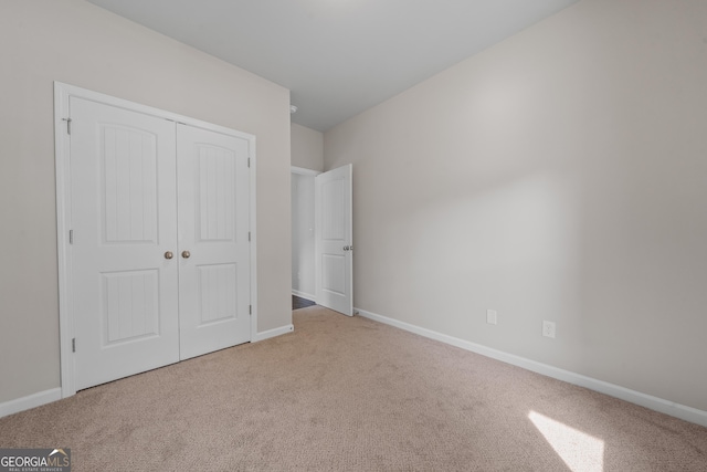 385 Orchard Land, Covington, GA 30014 - unfurnished bedroom with carpet floors, baseboards, and a closet