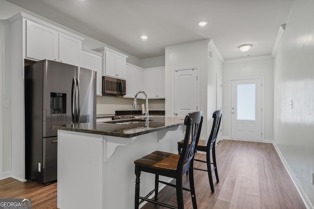 385 Orchard Land, Covington, GA 30014 - kitchen with stainless steel fridge with ice dispenser, dark stone countertops, a sink, white cabinets, and dark wood-type flooring