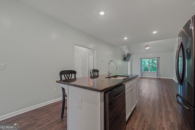 385 Orchard Land, Covington, GA 30014 - kitchen with freestanding refrigerator, a sink, dishwasher, a kitchen bar, and dark wood finished floors