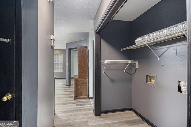 430 Pilgrim Ln, Powder Springs, GA 30127 - washroom featuring hookup for a washing machine, light wood finished floors, and a textured ceiling