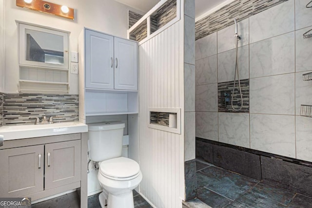 430 Pilgrim Ln, Powder Springs, GA 30127 - full bathroom featuring a tile shower, toilet, vanity, and tasteful backsplash