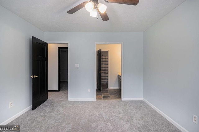 430 Pilgrim Ln, Powder Springs, GA 30127 - unfurnished bedroom featuring carpet, baseboards, a textured ceiling, connected bathroom, and ceiling fan