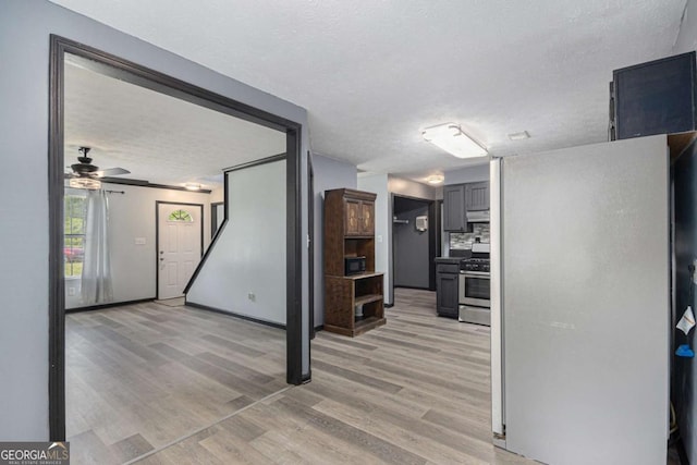 430 Pilgrim Ln, Powder Springs, GA 30127 - kitchen featuring gas stove, light wood finished floors, a ceiling fan, a textured ceiling, and tasteful backsplash