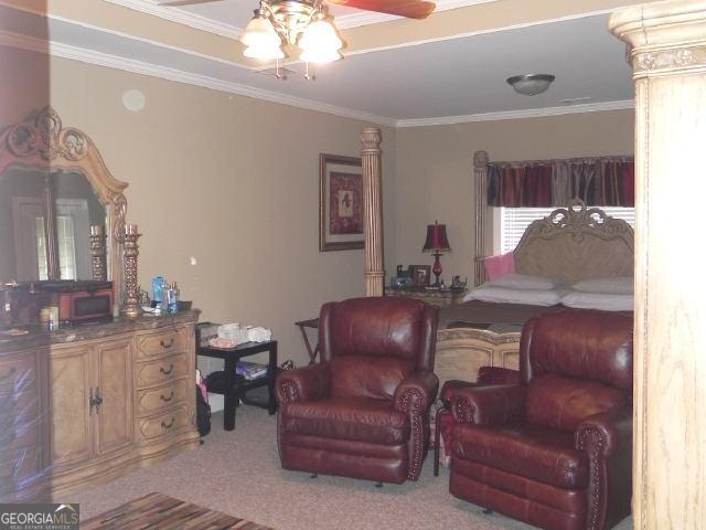 bedroom with light carpet and crown molding