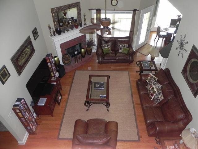 living room with wood finished floors and a fireplace