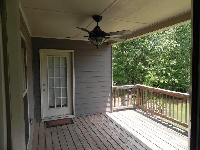 wooden terrace featuring a ceiling fan
