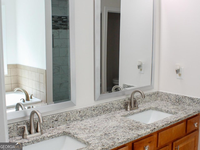141 Windward Hls, Mcdonough, GA 30253 - bathroom with double vanity, toilet, and a tub to relax in