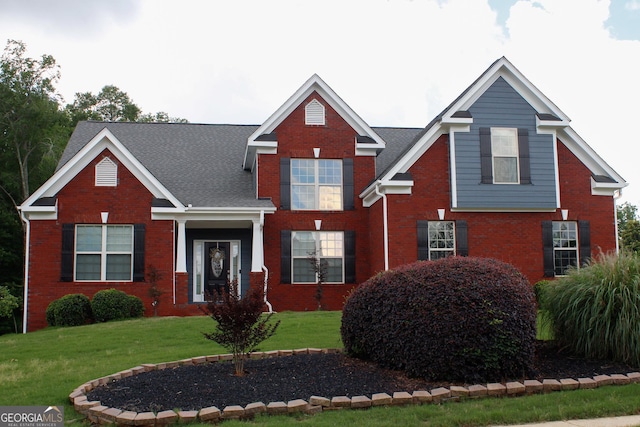 traditional-style home with brick siding and a front yard