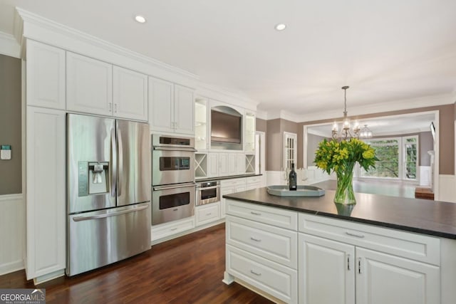 10660 Dunoon Dr, Alpharetta, GA 30022 - kitchen featuring appliances with stainless steel finishes, dark countertops, white cabinetry, glass insert cabinets, and ornamental molding