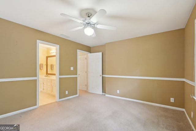 10660 Dunoon Dr, Alpharetta, GA 30022 - unfurnished bedroom featuring carpet, baseboards, connected bathroom, and a ceiling fan
