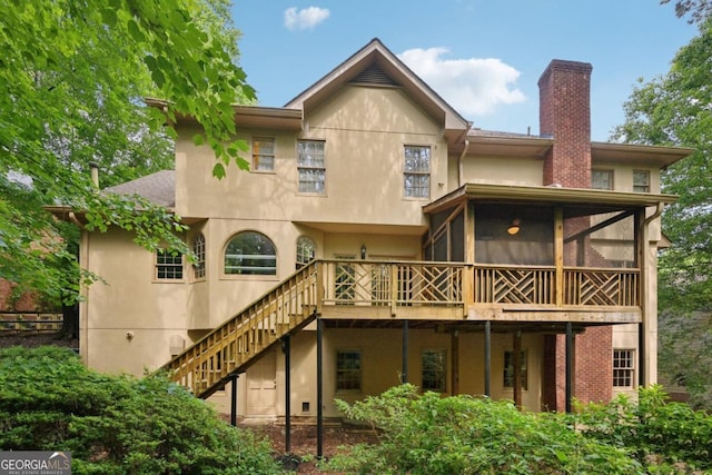 10660 Dunoon Dr, Alpharetta, GA 30022 - back of house featuring stucco siding, stairway, a sunroom, and a chimney